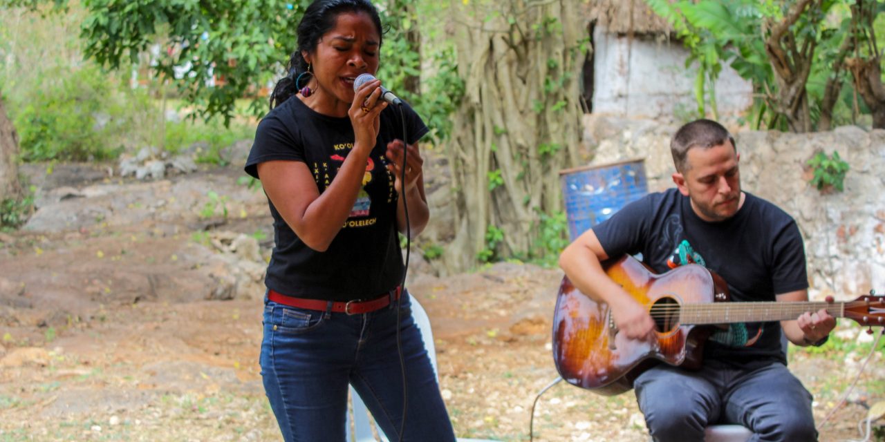 Niños y niñas cantan al agua desde un cenote en Homún