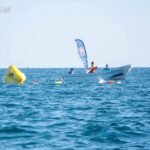 Playa, mar y nadadores de alto rendimiento en Progreso